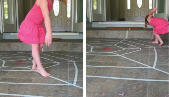 A girl walking on the spider web created on the floor
