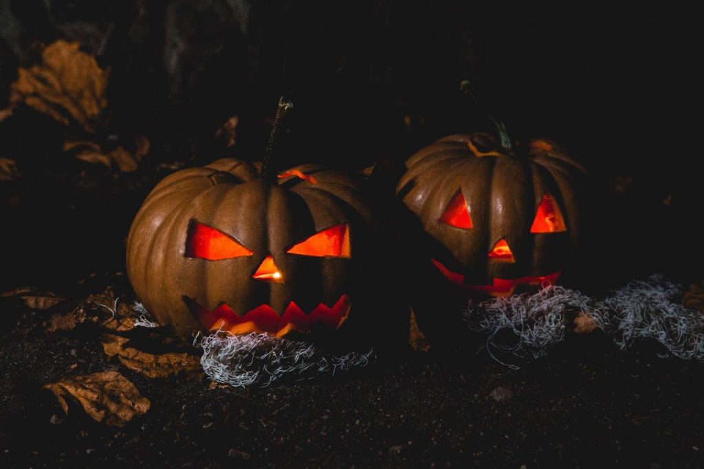 Pumpkins with scary halloween carvings on it