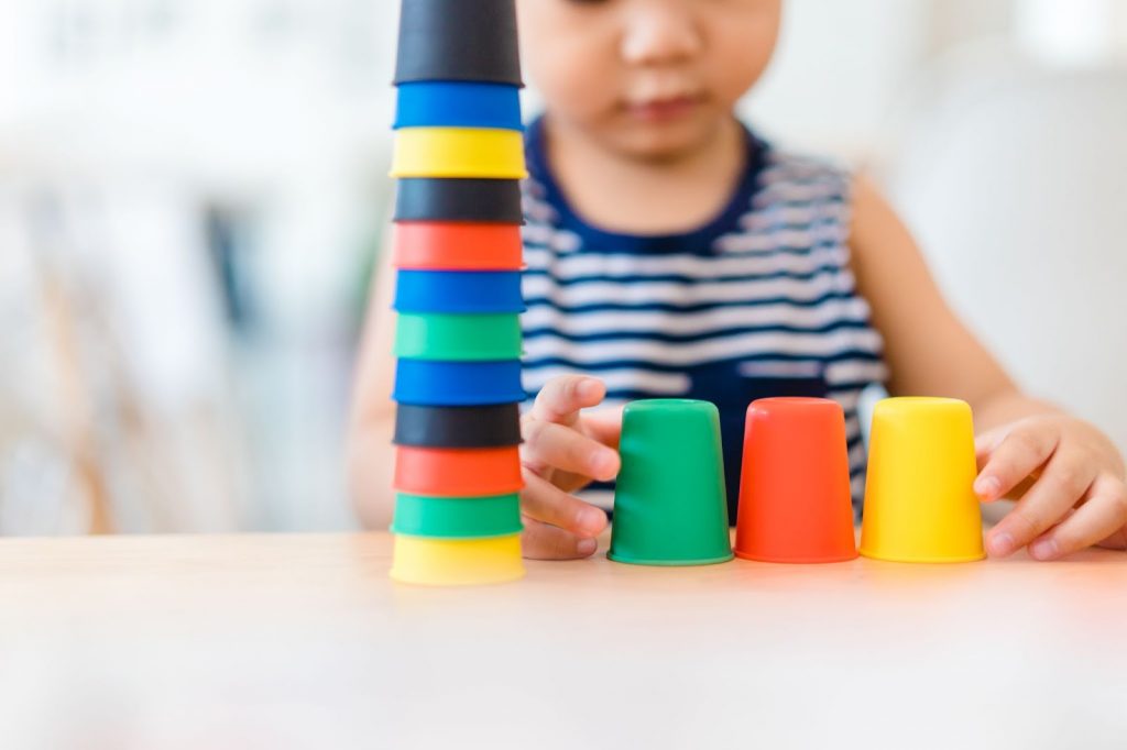 A kid stacking cups