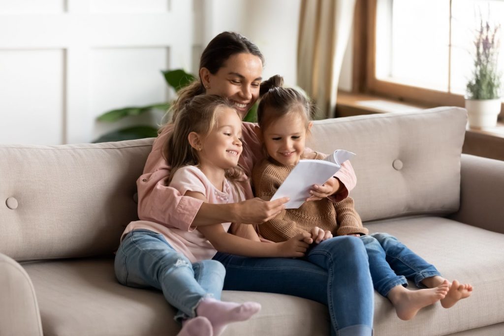 Kids and mother reading a story together