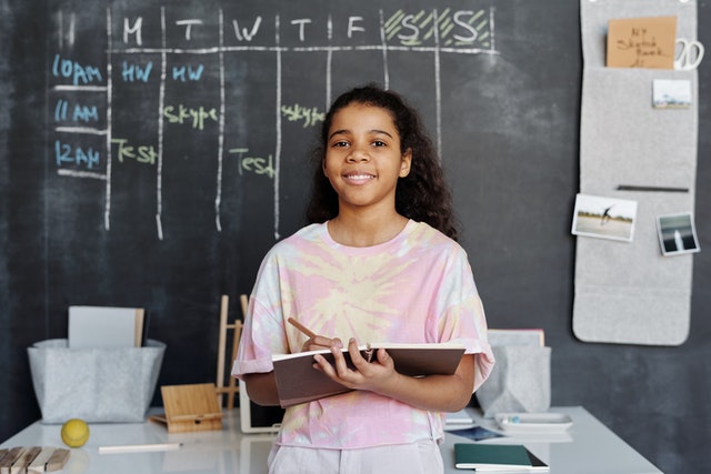 Girl forward of black board