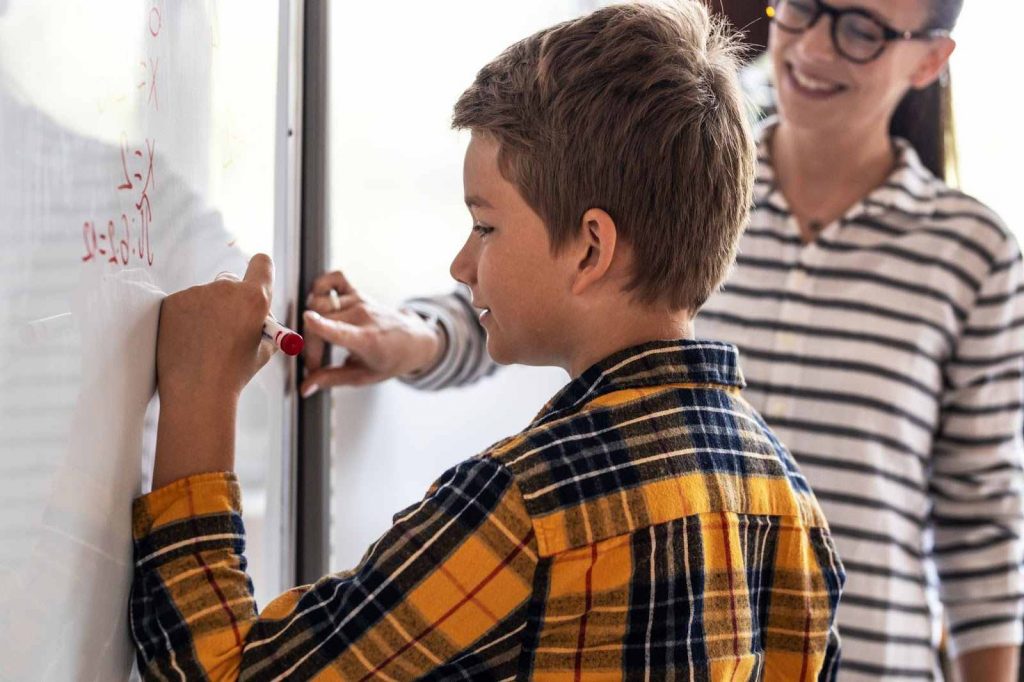 Teacher helping a student with math problem