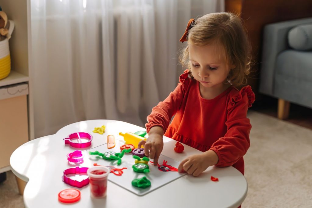 Kid playing with playdough