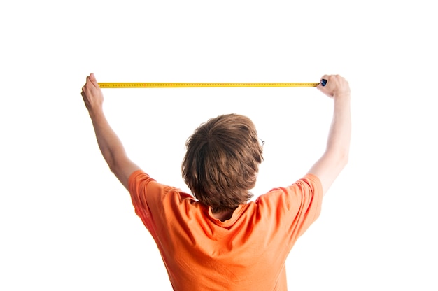 A boy measuring the length of the wall