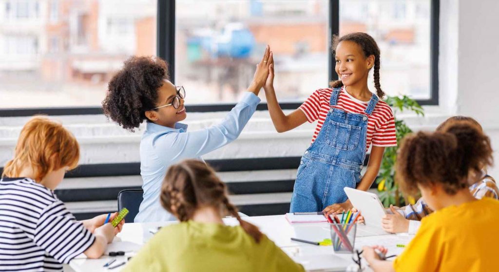 Kid giving teacher high five