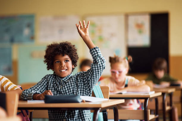 A boy raising hand in the classroom