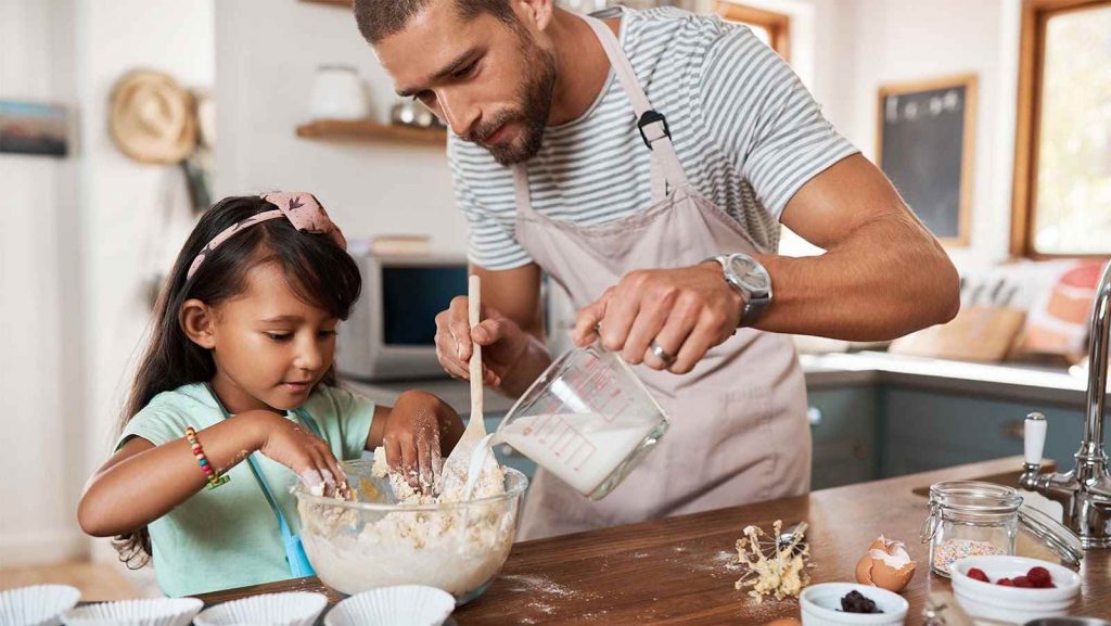 Daughter and father cooking