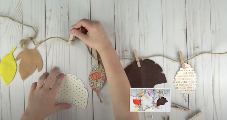 A person making a thanksgiving garland