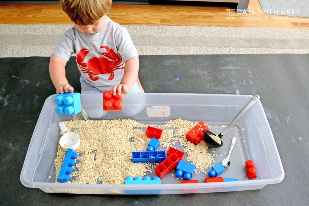 Kid playing with a sensory bin