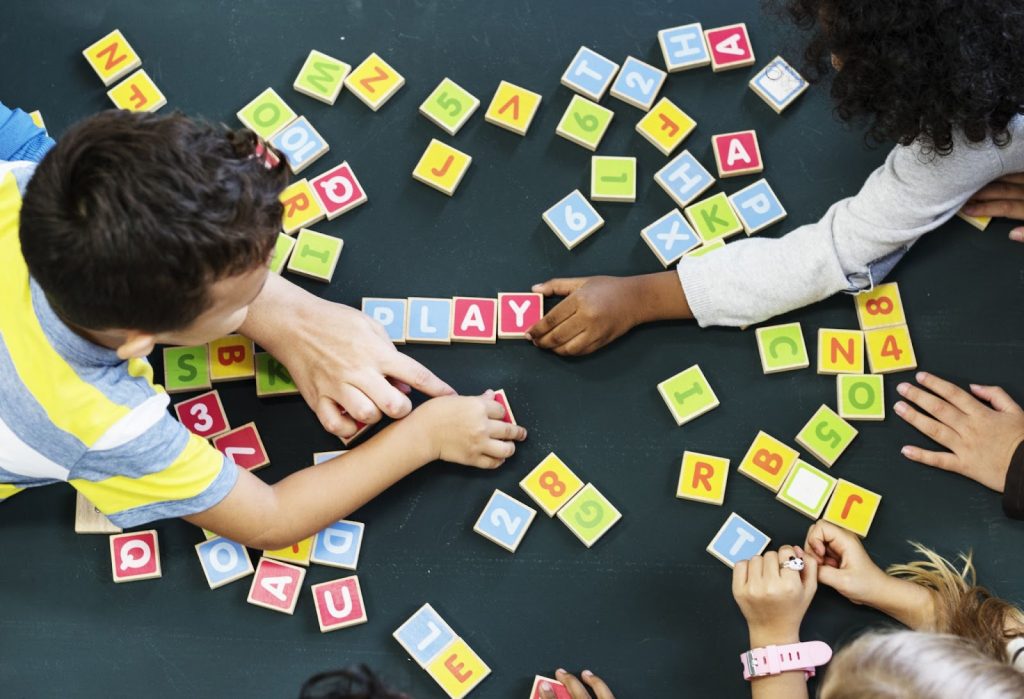 Kids playing with letter tiles