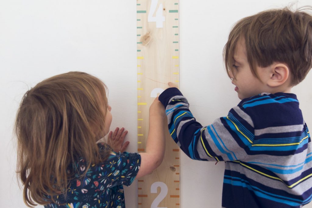 Two kids measuring height