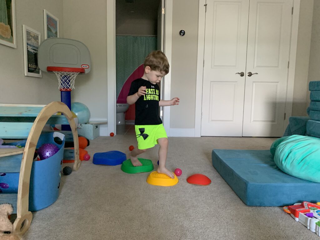 A kid playing obstacle course