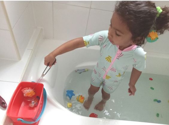 Toddler playing in water tub