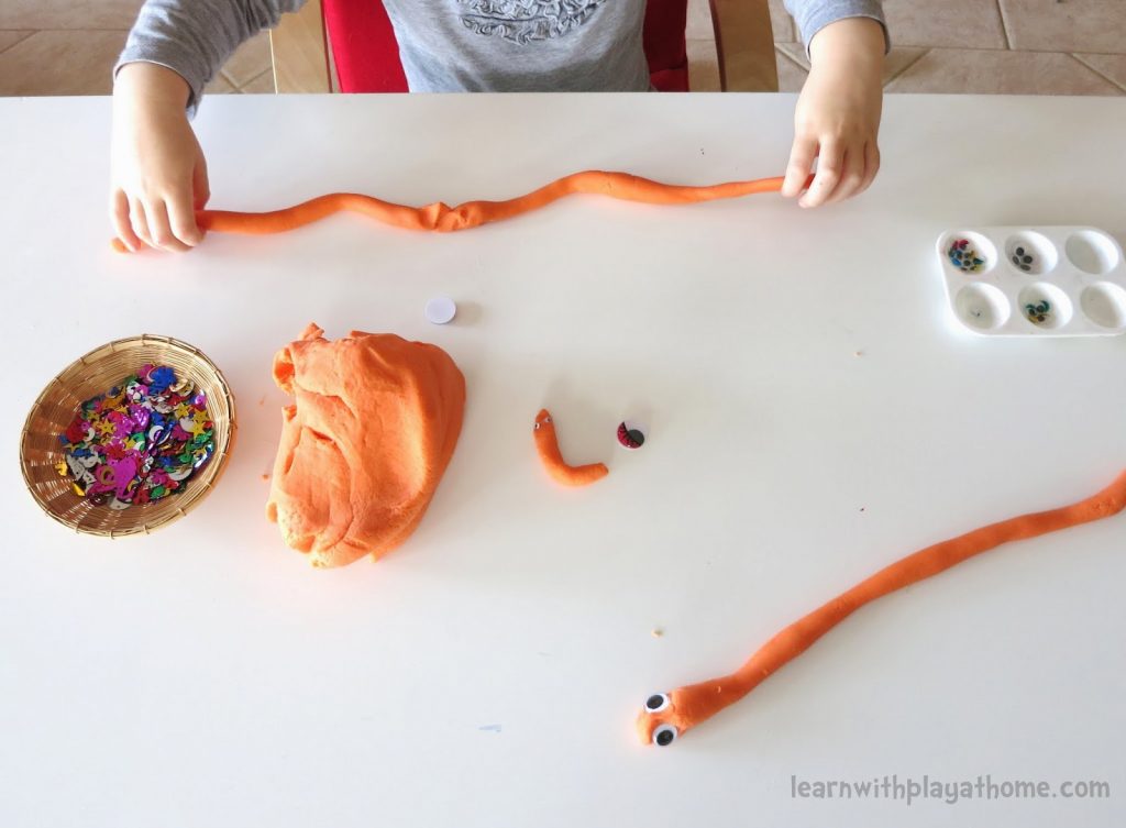 A Girl Making Snake with Clay