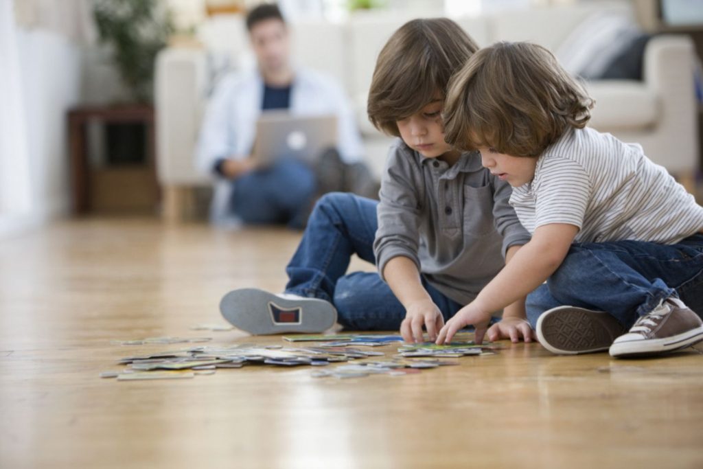 Brother’s putting together the puzzles on floor