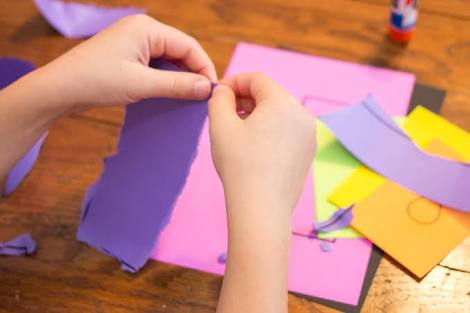 A kid tearing paper