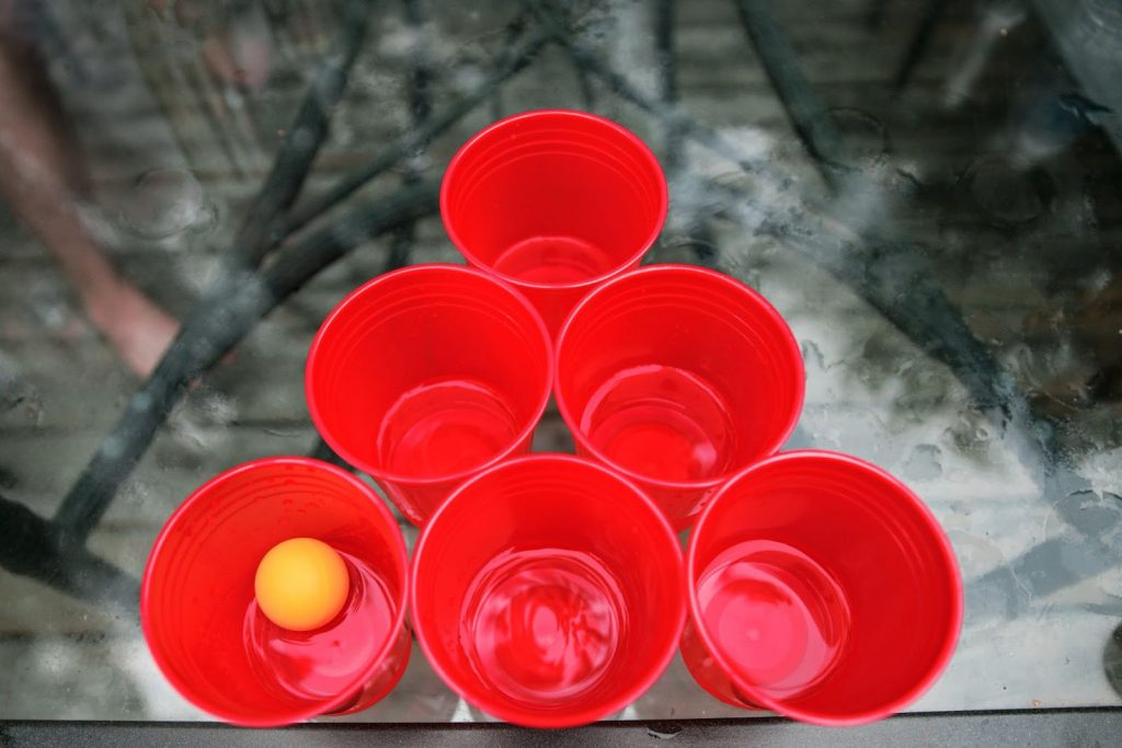 An orange ball inside a red glass