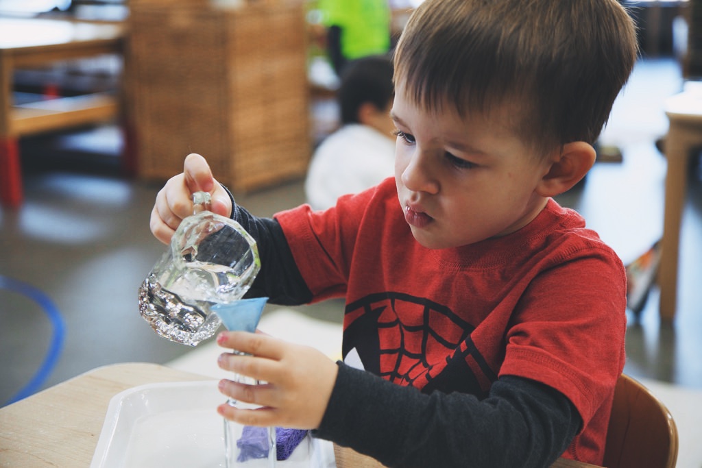 A kid pouring water