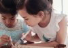 Two girls performing a science experiment