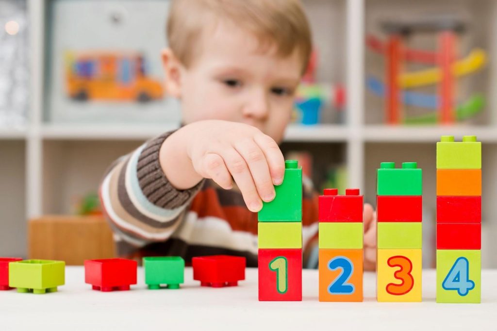 A boy using counting blocks