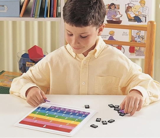 A boy playing with colorful fraction tiles