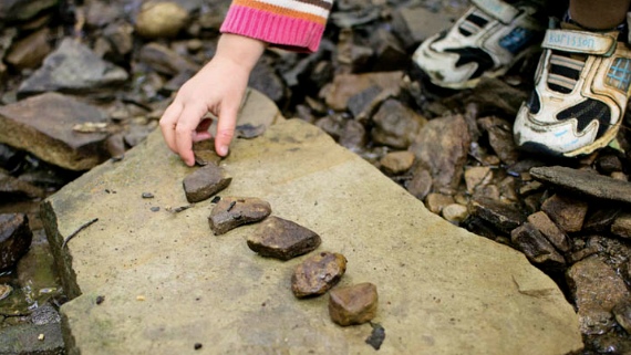 Kid counting stones