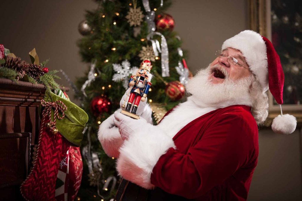 A man dressed as Santa laughing