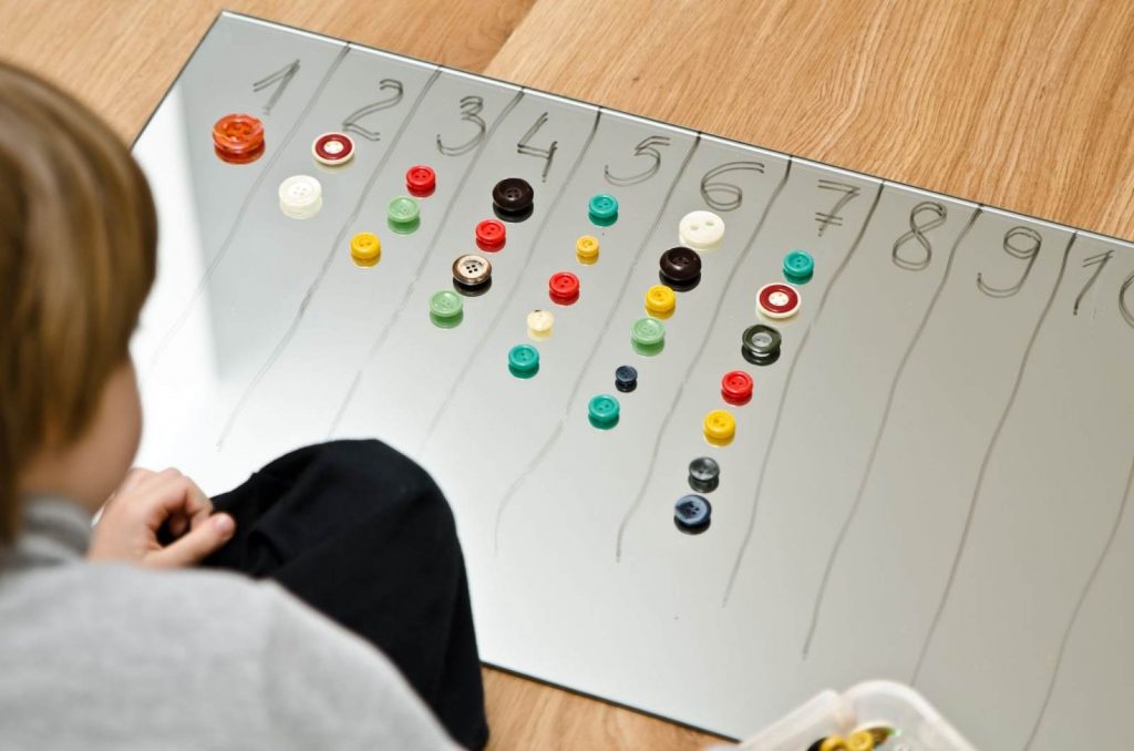 Kid counting with buttons