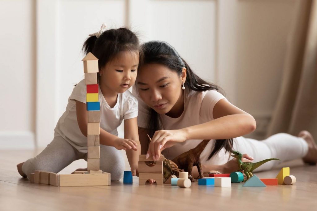 Mother and daughter playing with building blocks