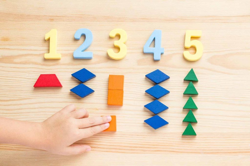 Kid using math manipulatives