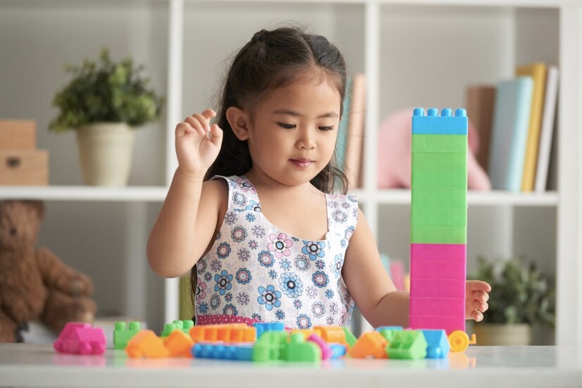 A Girl playing Decomposing Numbers Game with Lego Bricks