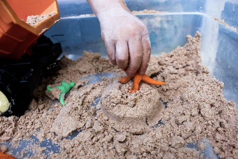 Kid playing with edible sand