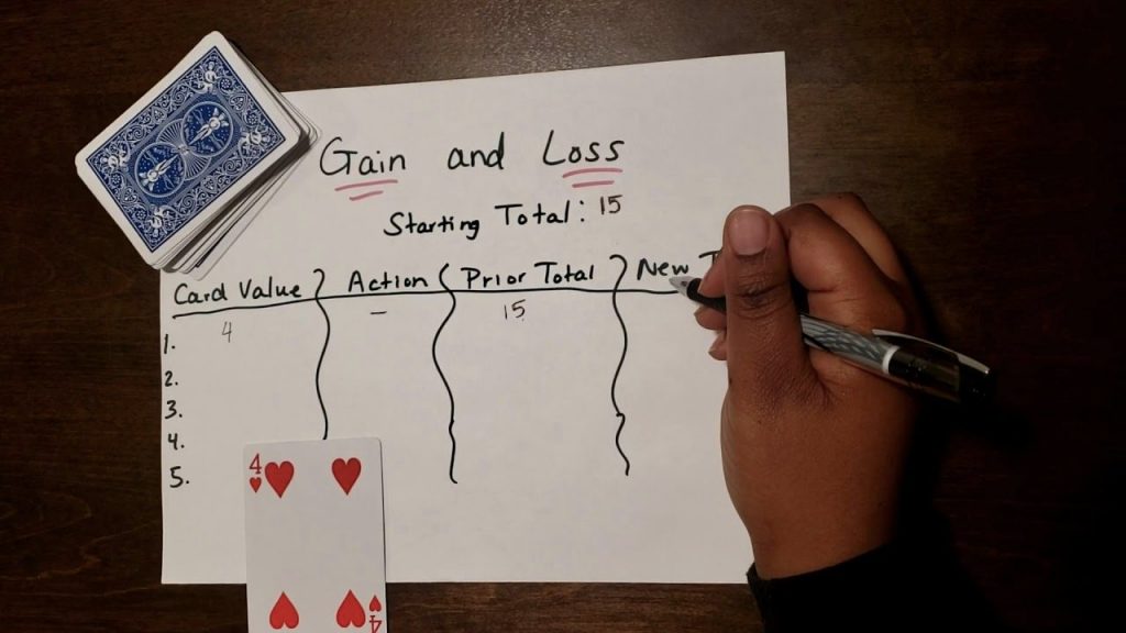 A person writing the card values