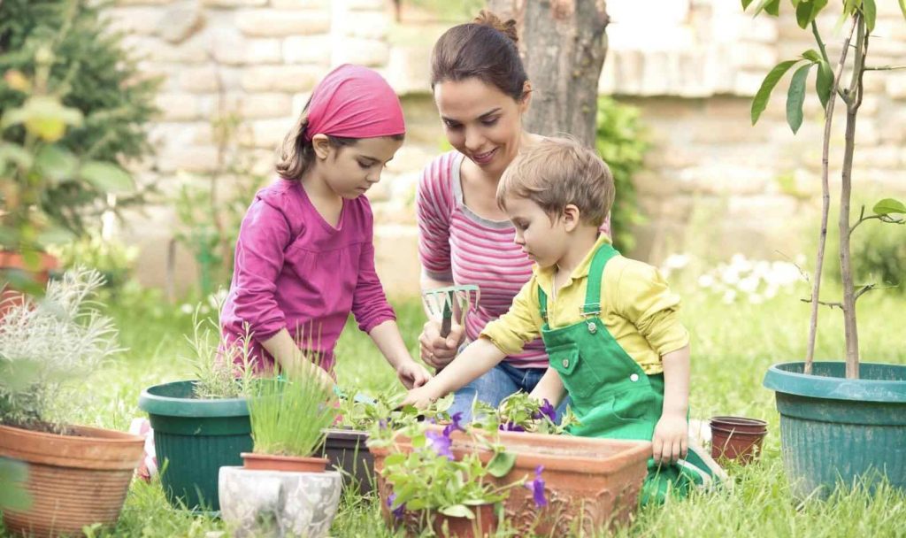 Kids engaging in gardening with mother