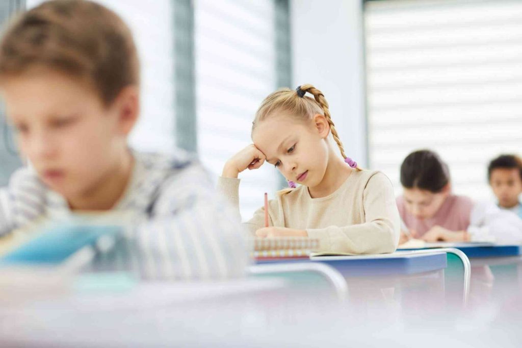 Kids writing in a classroom