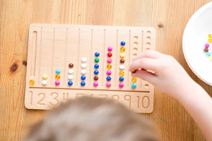 Kid counting on beads board