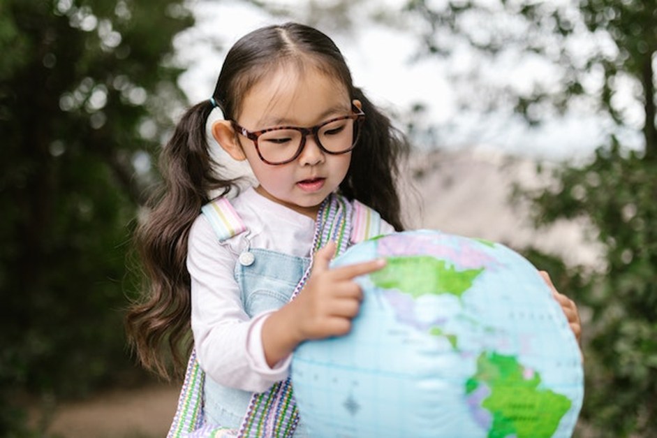 Kid with globe balloon understanding spring poems