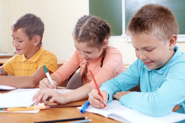 Kids writing on a Paper