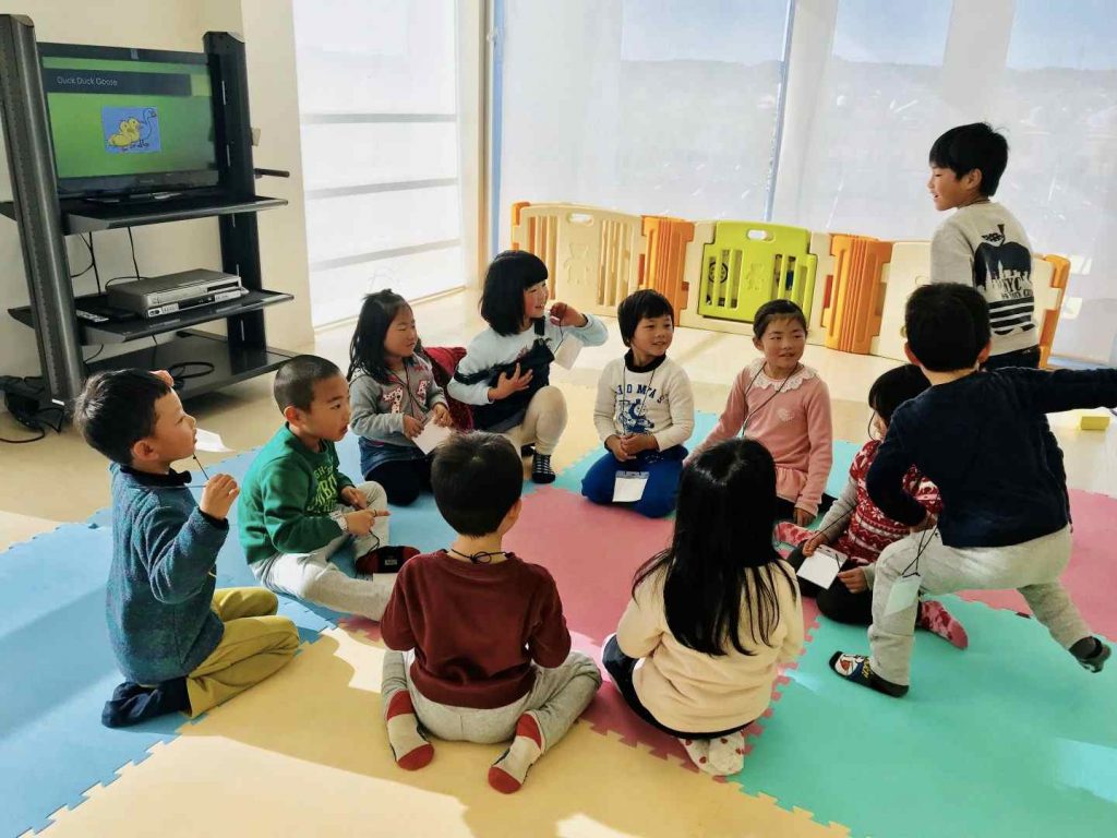 Kids playing duck duck goose