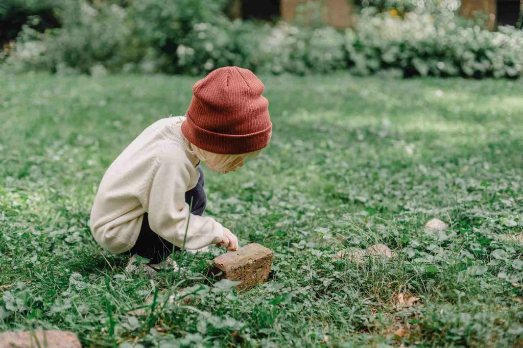 Kid looking at a bug