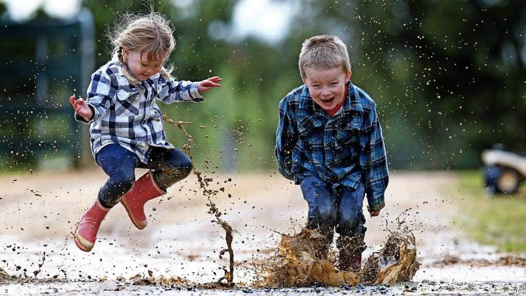 Kids jumping in puddle