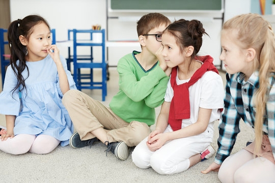 Kids playing telephone in class