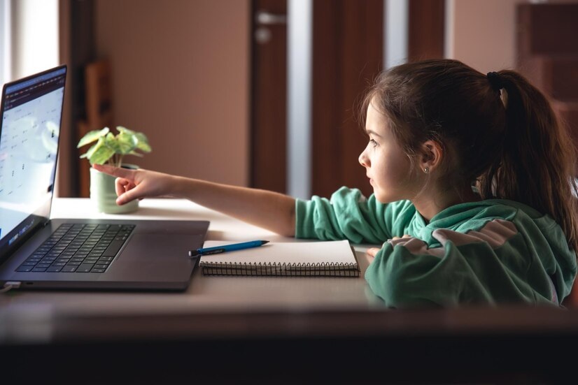 A girl reading stories on laptop