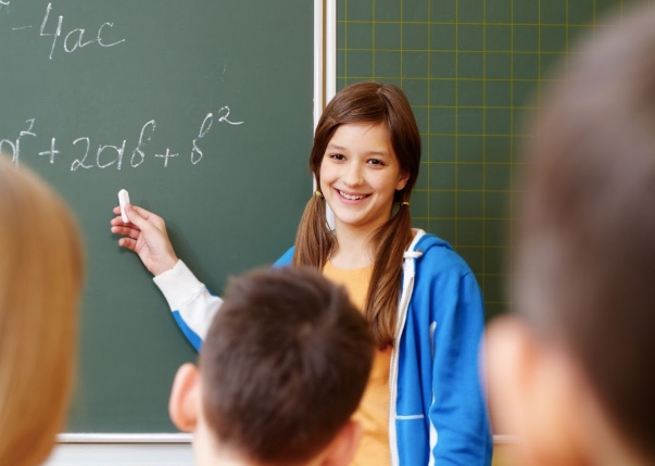 A student explaining math problems to the class