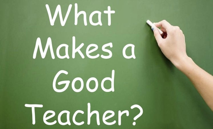 Someone writing what makes a good teacher on a green board
