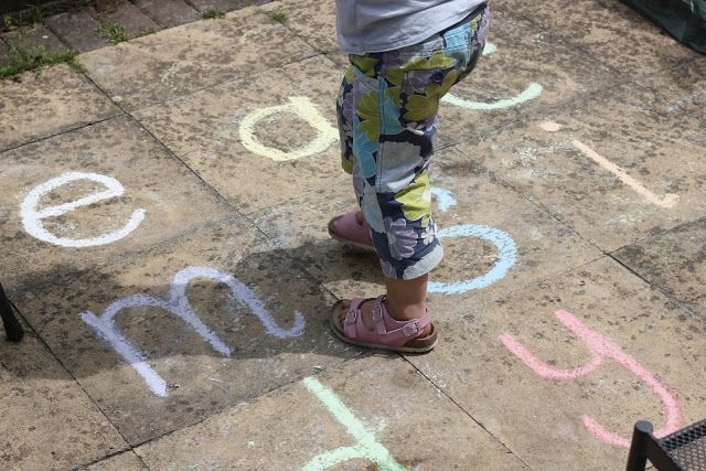 Kid jumping on letters