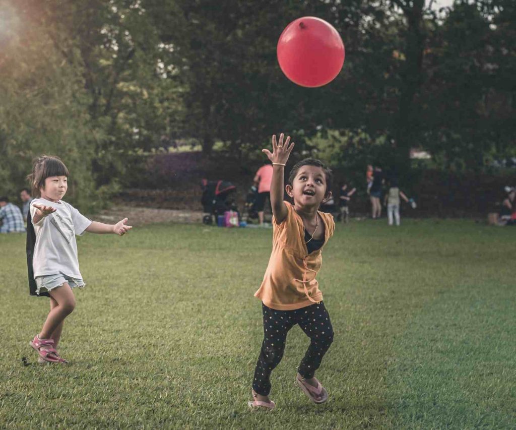 Kids playing balloon toss