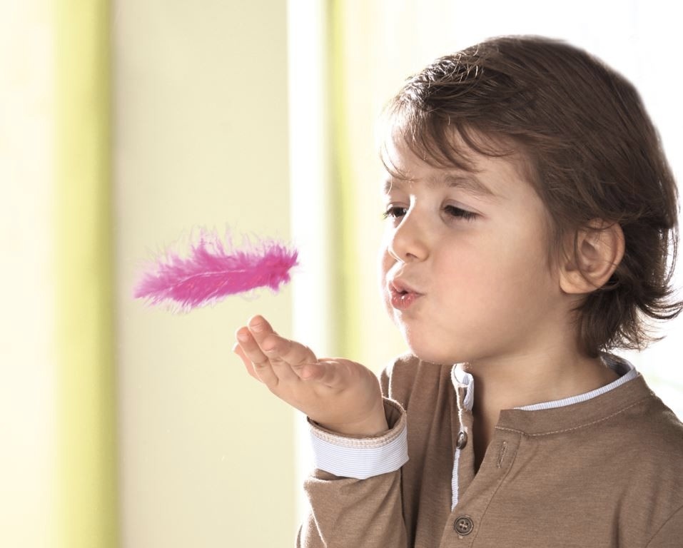 kid blowing feather