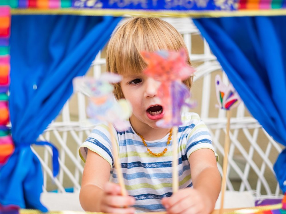 Kid playing with puppets