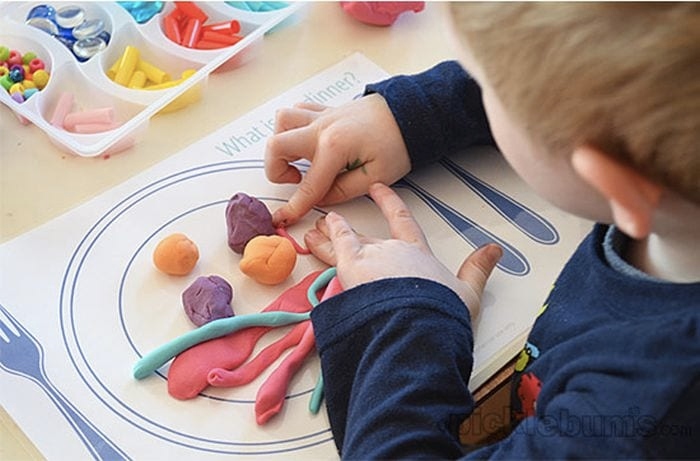 kid using playdough